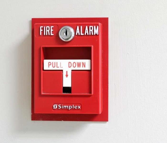 white wall with red fire alarm